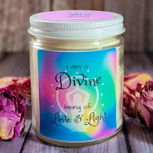 Load image into Gallery viewer, Candle jar with a colorful label reading 'I am a Divine being of Love & Light' on a wooden surface with dried flowers.