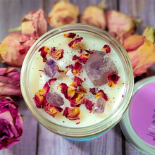 Load image into Gallery viewer, Candle jar with dried flowers and purple crystals on a wooden surface with dried roses.