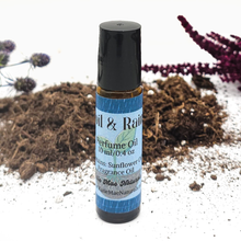 Load image into Gallery viewer, Roll-on perfume oil bottle with a blue label on a natural background