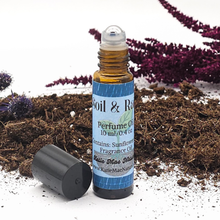 Load image into Gallery viewer, Perfume oil bottle labeled 'Soil & Rain' on a natural background with plants.