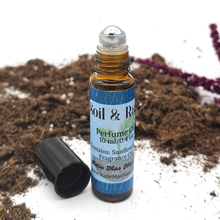 Load image into Gallery viewer, Roll-on perfume oil bottle with blue label on a natural background