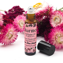 Load image into Gallery viewer, Roll-on perfume bottle with pink label on a white background