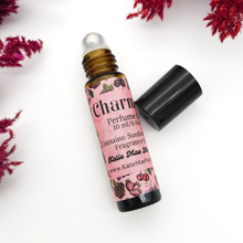Load image into Gallery viewer, Roll-on perfume bottle with pink label on a white background