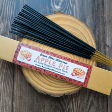 Load image into Gallery viewer, Katie Mae Naturals Apple Pie incense sticks on a wooden log with a label.