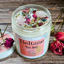 Load image into Gallery viewer, Jar of Beltane May Day candle with decorative elements on a wooden surface