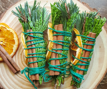 Load image into Gallery viewer, Yule Celebration smudge stick with dried orange and cinnamon
