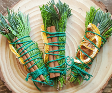 Load image into Gallery viewer, Yule Celebration smudge stick with dried orange and cinnamon