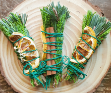 Load image into Gallery viewer, Yule Celebration smudge stick with dried orange and cinnamon