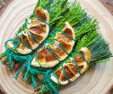 Load image into Gallery viewer, Yule Celebration smudge stick with dried orange and cinnamon