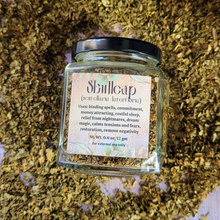 Load image into Gallery viewer, Organic dried skullcap in an apothecary jar with a label on a wooden background