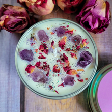 Load image into Gallery viewer, Candle with purple crystals and rose petals on a wooden surface with dried roses.
