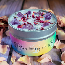 Load image into Gallery viewer, Candle in a tin with colorful label and rose petals on a wooden surface
