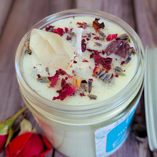 Load image into Gallery viewer, Candle in a jar with dried flowers on a wooden surface

