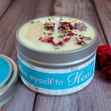 Load image into Gallery viewer, Candle in a tin with decorative elements and 'I allow myself to Heal' label on a wooden surface.
