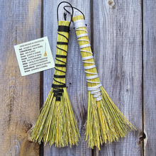 Load image into Gallery viewer, Two yellow brooms with black and white handles on a wooden surface.

