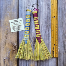 Load image into Gallery viewer, Two colorful brooms on a wooden surface with a ruler for scale.
