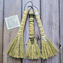 Load image into Gallery viewer, Three decorative brooms with different color patterns on a wooden background

