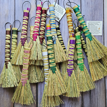 Load image into Gallery viewer, Set of decorative brooms with colorful handles on a wooden background

