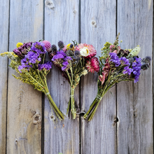 Load image into Gallery viewer, Three bouquets of flowers arranged in a heart shape on a wooden surface

