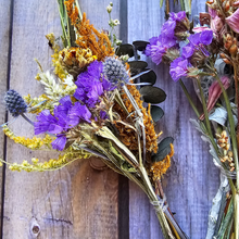 Load image into Gallery viewer, Bouquet of dried flowers with purple, orange, and green colors on a wooden background
