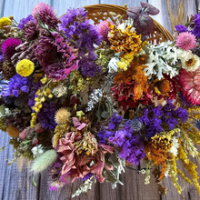 Load image into Gallery viewer, Colorful dried flower arrangement in a woven basket on a wooden surface
