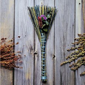 Mini blue decorative broom adorned with dried flowers 