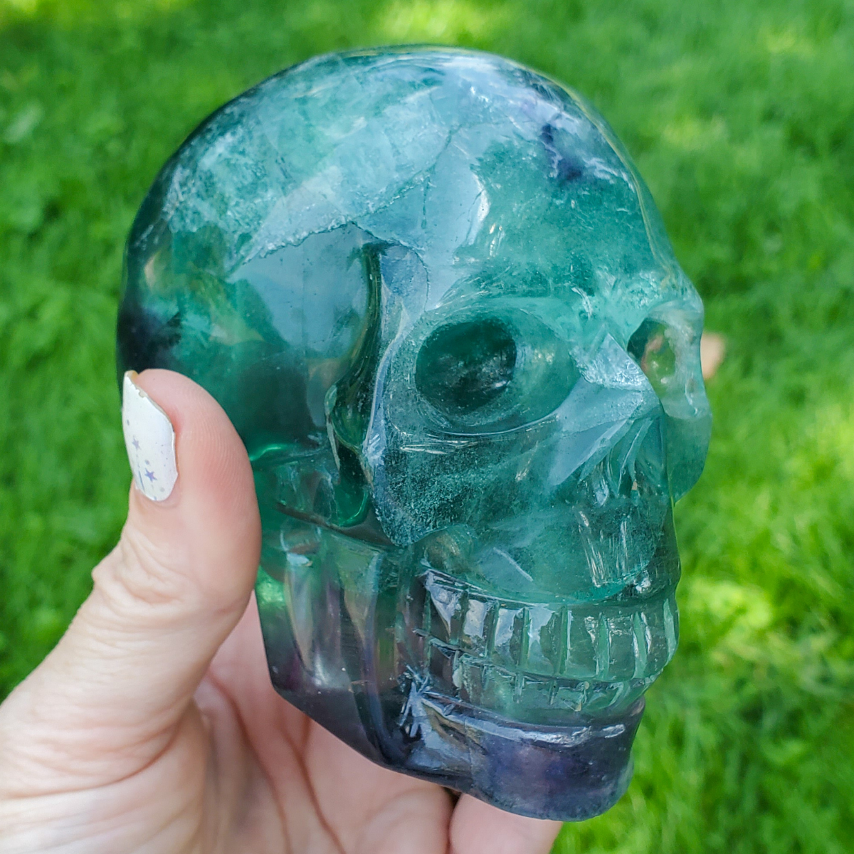 Large rainbow fluorite skull carving 