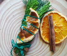 Load image into Gallery viewer, Yule Celebration smudge stick with dried orange and cinnamon 
